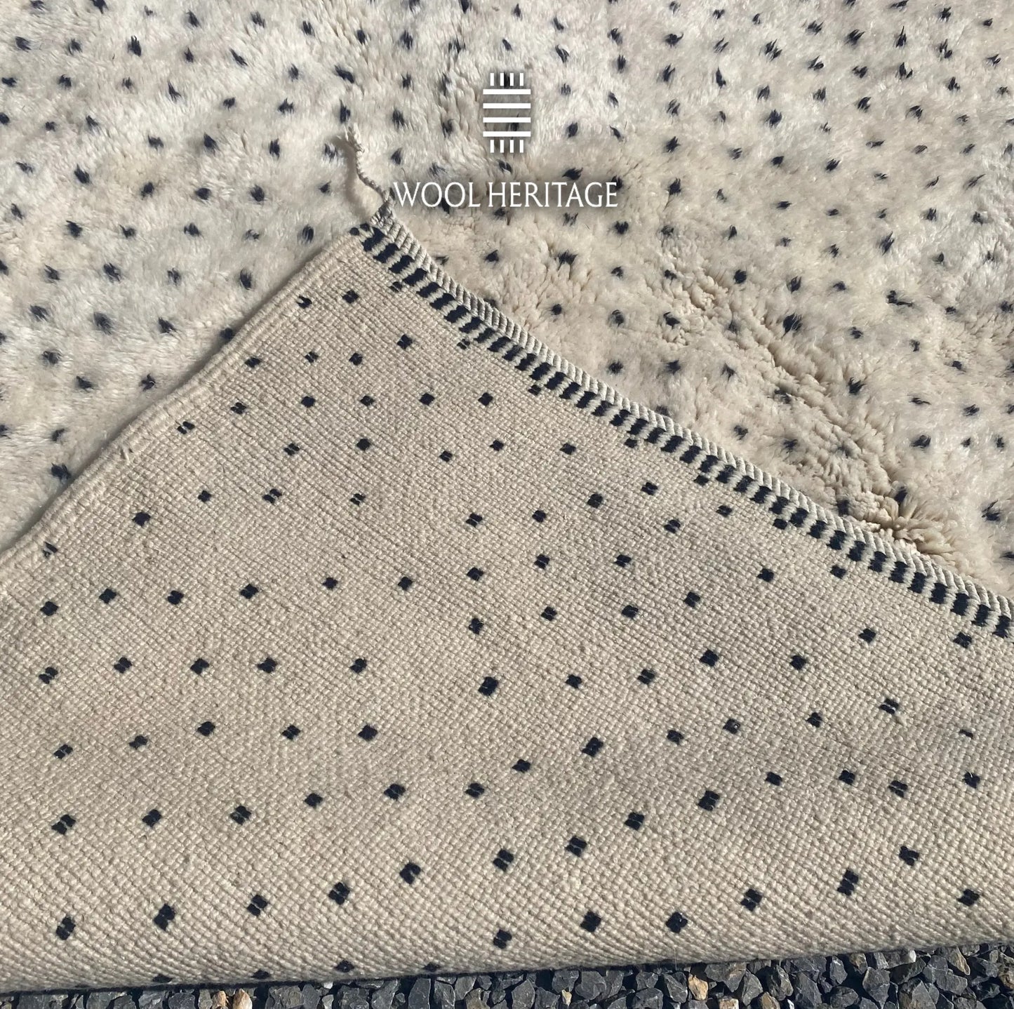 Back of AMUD Beni Mrirt rug showing its woven construction, regularly spaced charcoal colourwork, and finished edge