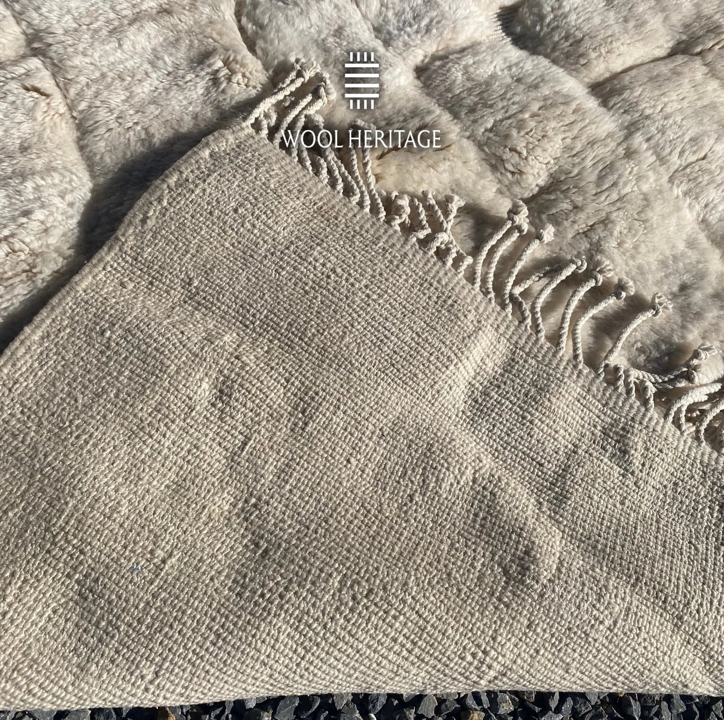 Back of IGHREM hand-knotted Moroccan rug showing its woven construction and fringe finish