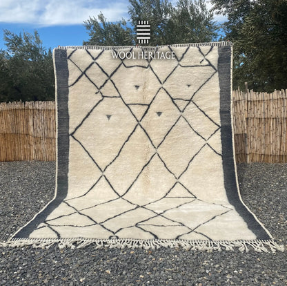 ADRAR hand-knotted ivory and charcoal Moroccan wool rug displayed outdoors in a full front view