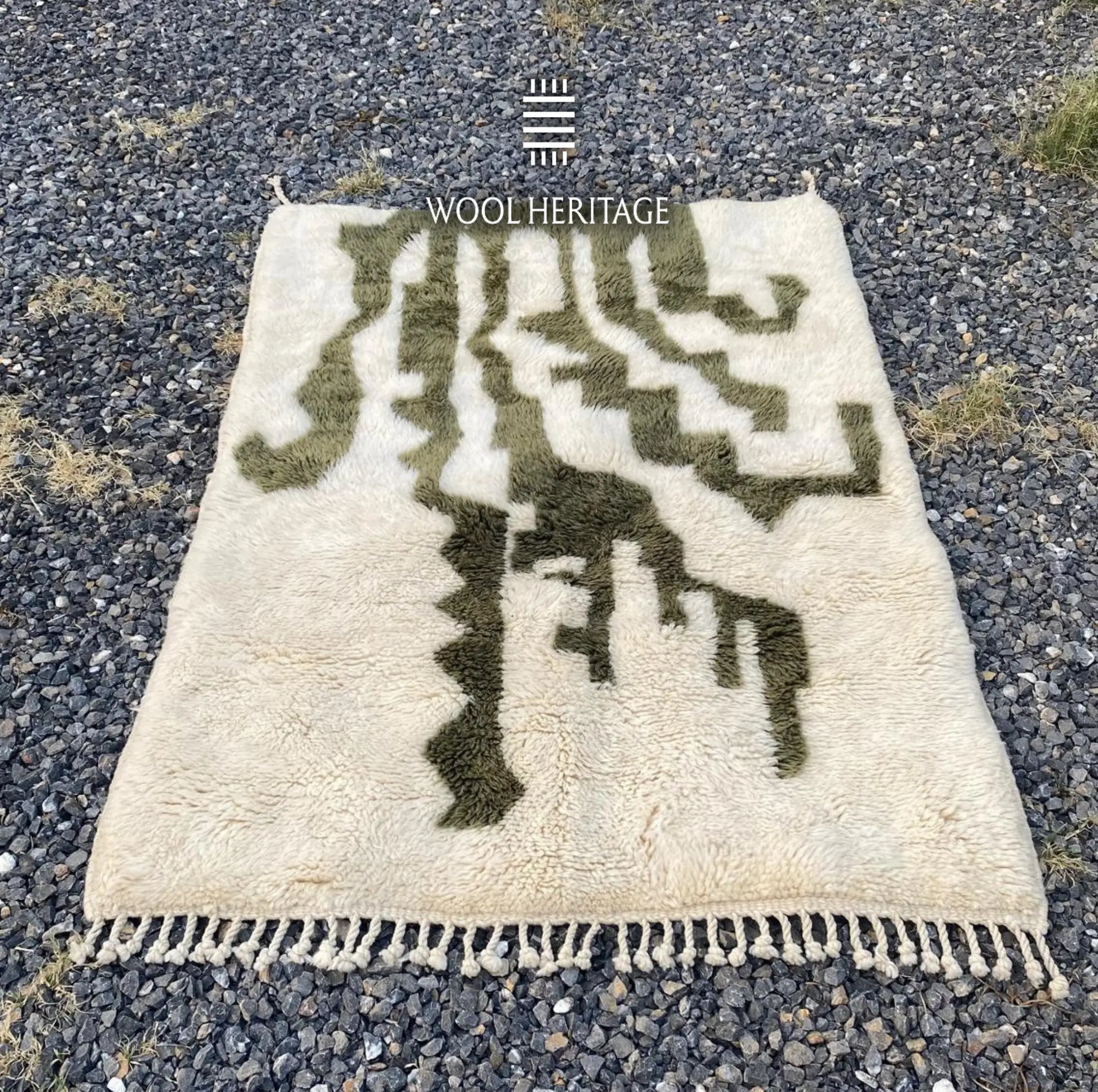 AKNARI Beni Mrirt rug laid flat, showing its complete dark olive botanical composition on warm ivory