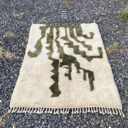 AKNARI Beni Mrirt rug laid flat, showing its complete dark olive botanical composition on warm ivory