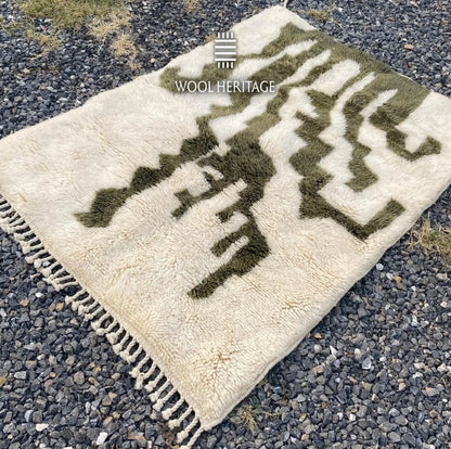 Angled view of AKNARI Moroccan rug showing its branching olive cactus pattern and hand-finished fringe