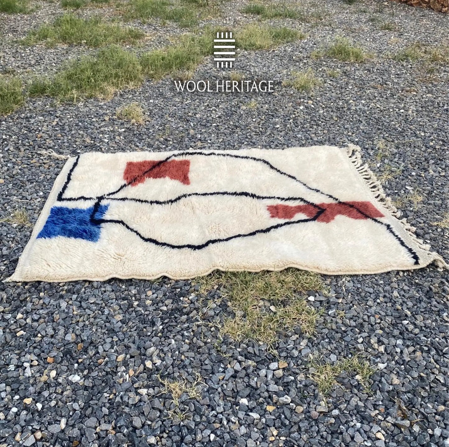 Full horizontal view of AMARG abstract rug showing cobalt-blue and burgundy forms connected by flowing black lines