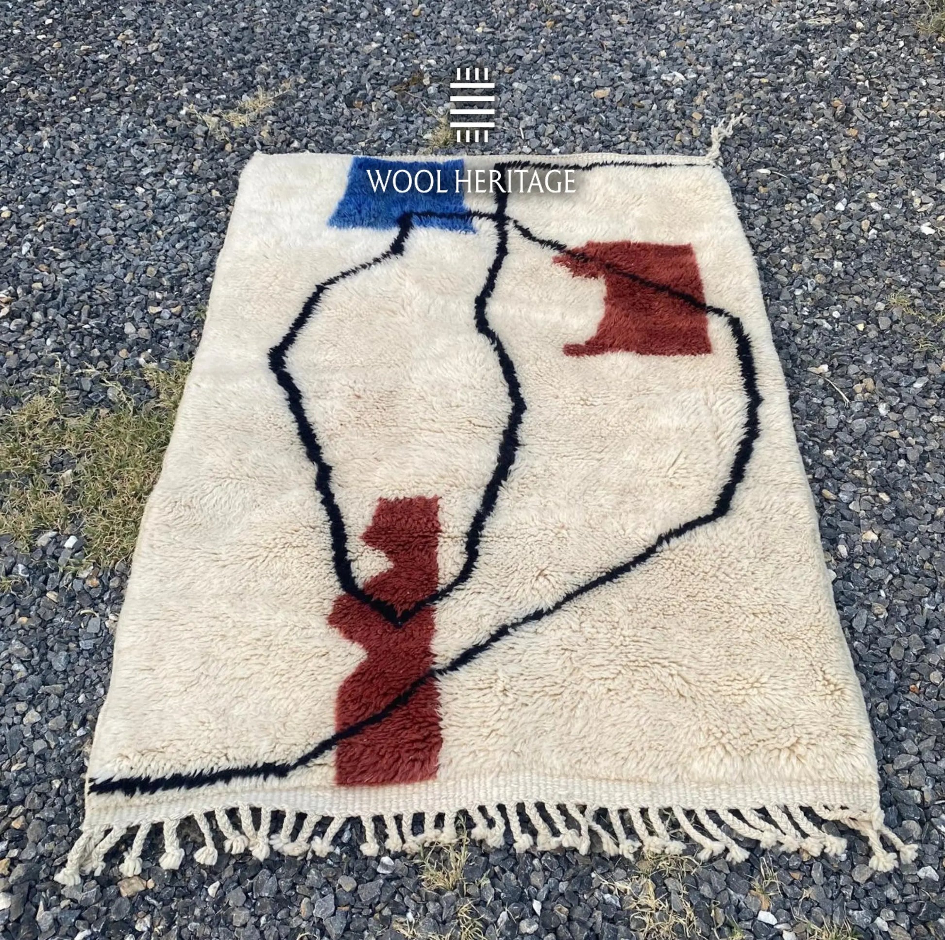 AMARG Beni Mrirt rug laid flat, showing its complete abstract composition on a warm ivory field