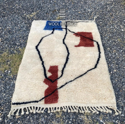 AMARG Beni Mrirt rug laid flat, showing its complete abstract composition on a warm ivory field