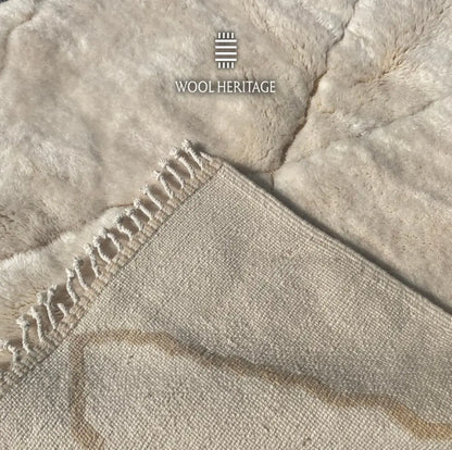 Back of AMLAL Beni Mrirt rug showing its woven construction, ivory wool, and subtle tone-on-tone geometric pattern