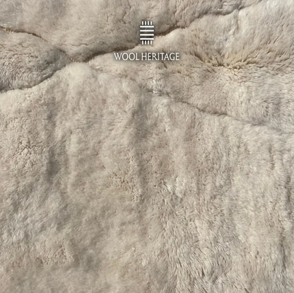 Close-up of AMLAL rug showing its soft ivory Moroccan wool pile and barely visible geometric texture