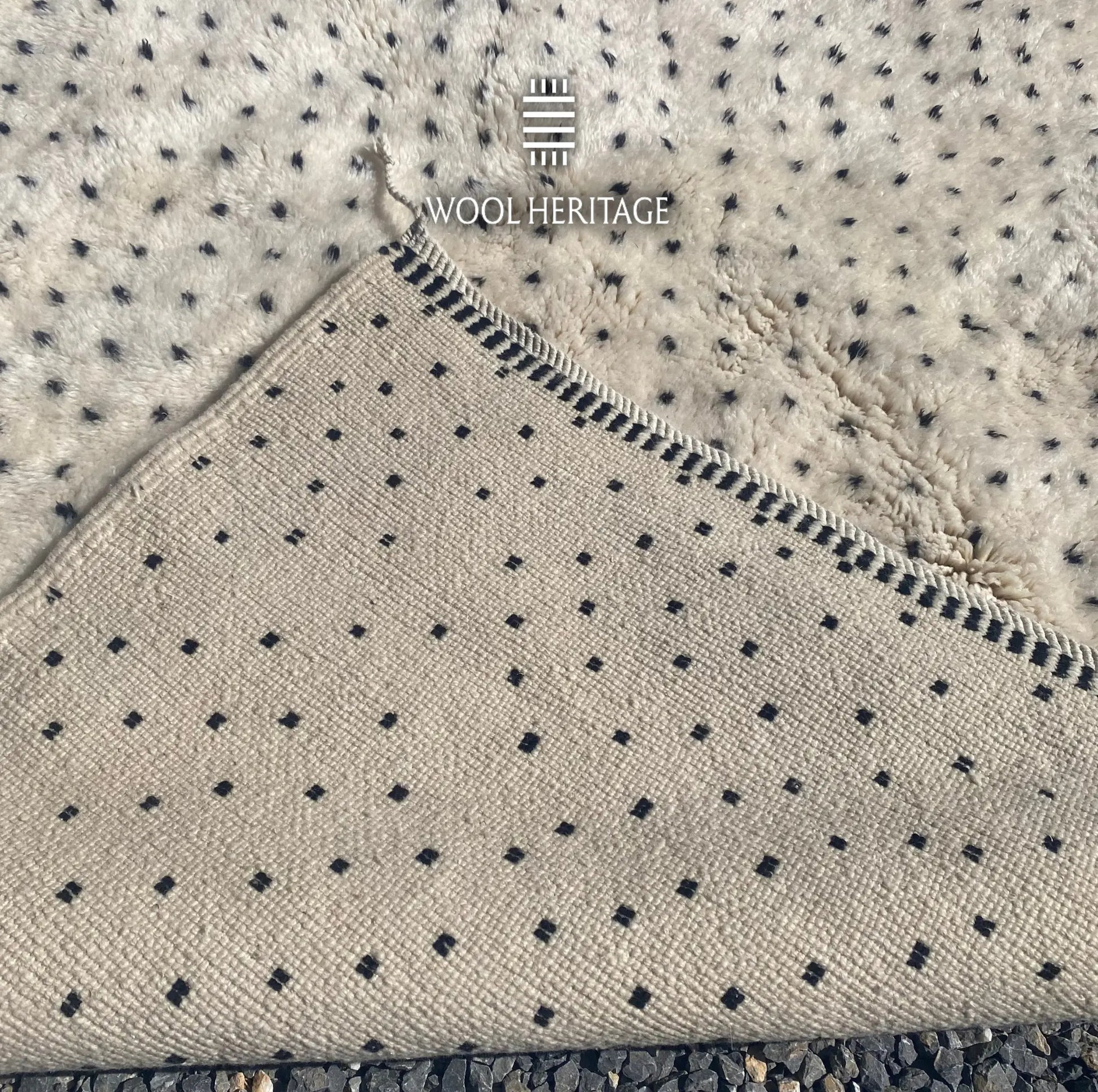 Back of AMUD Beni Mrirt rug showing its woven construction, regularly spaced charcoal colourwork, and finished edge