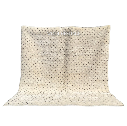 AMUD ivory Beni Mrirt rug with small charcoal seed-like dots in an isolated product view