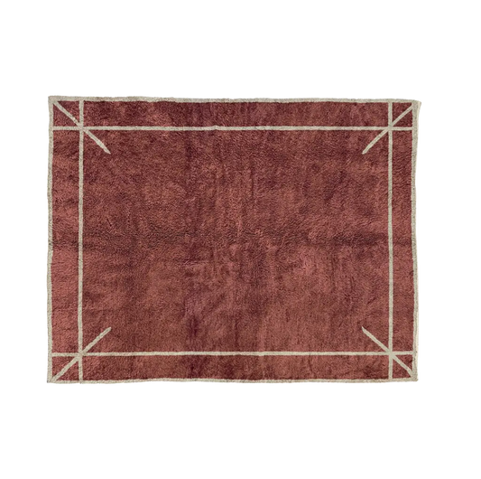 ASMA oxblood Beni Mrirt rug with a thin ivory border and marked corners, hand-knotted in M’rirt from Moroccan wool