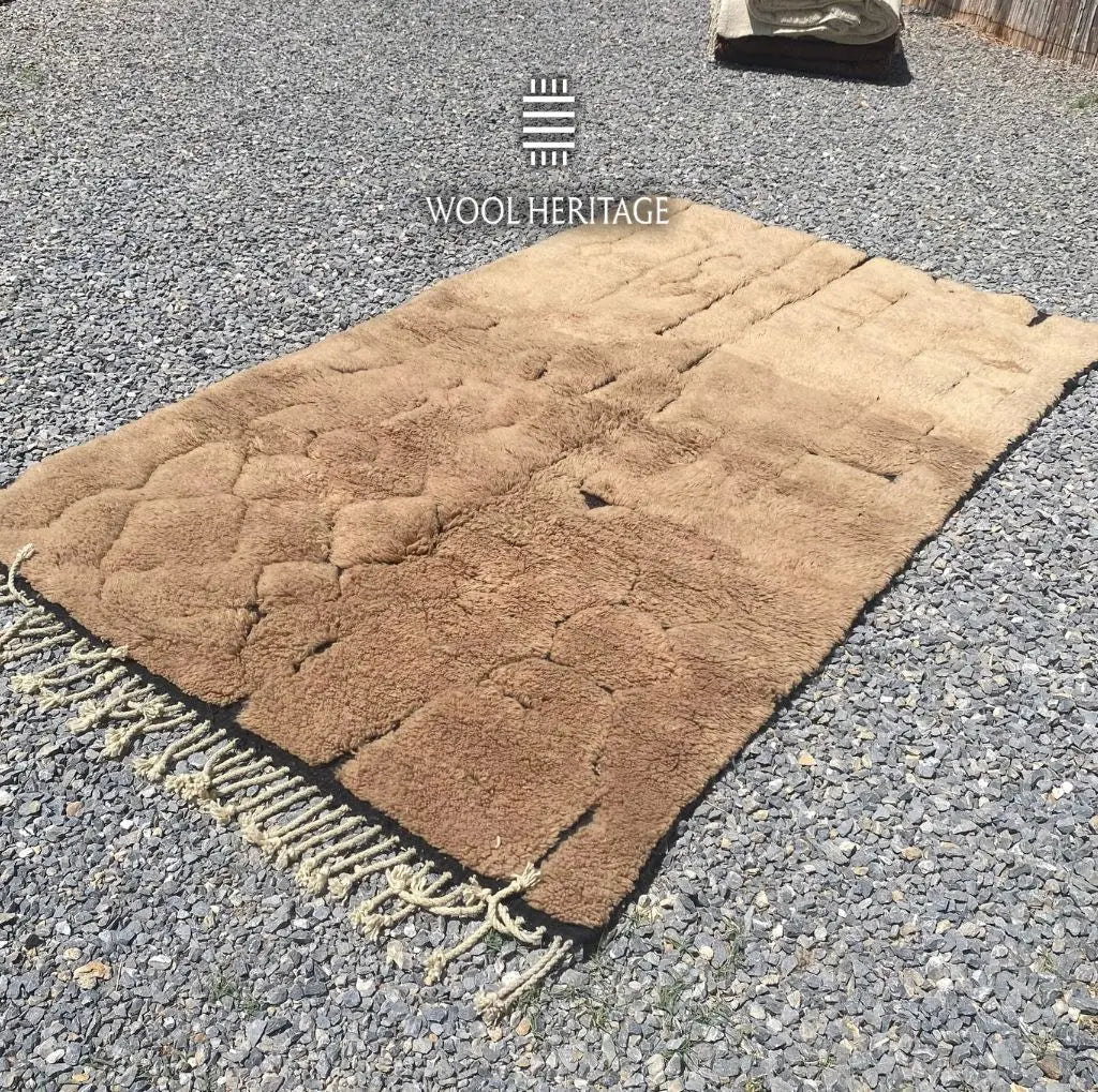 AZAGHAR camel-brown Moroccan wool rug shown at an angle with sculptural raised sections