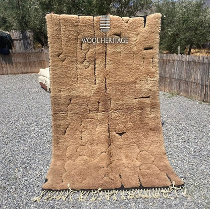 AZAGHAR camel-brown Moroccan wool rug shown upright outdoors with raised textured forms