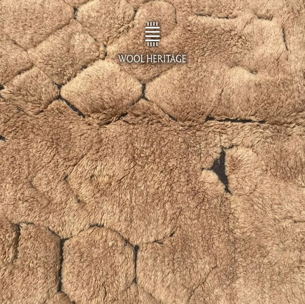 Close-up of AZAGHAR’s irregular pebble-like raised wool forms in camel brown