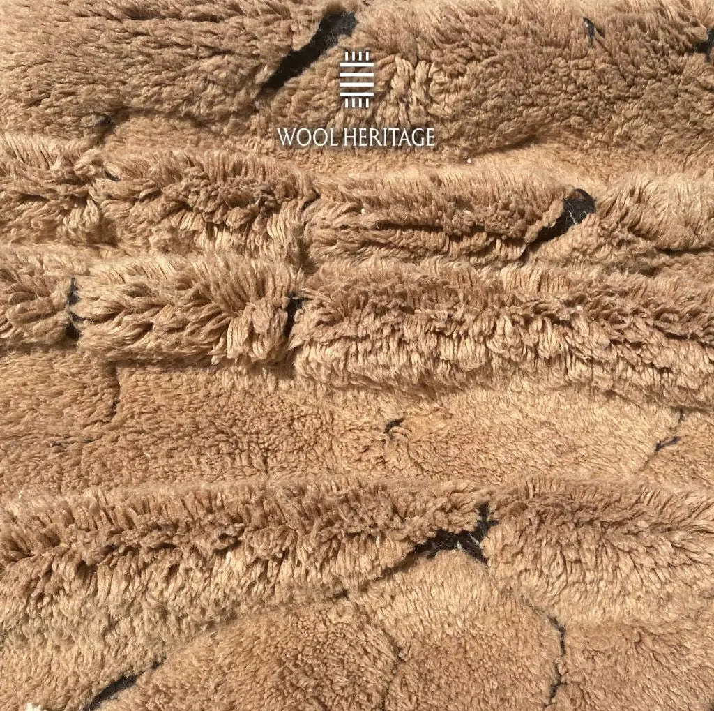 Close-up of AZAGHAR camel-brown wool pile and raised abstract texture