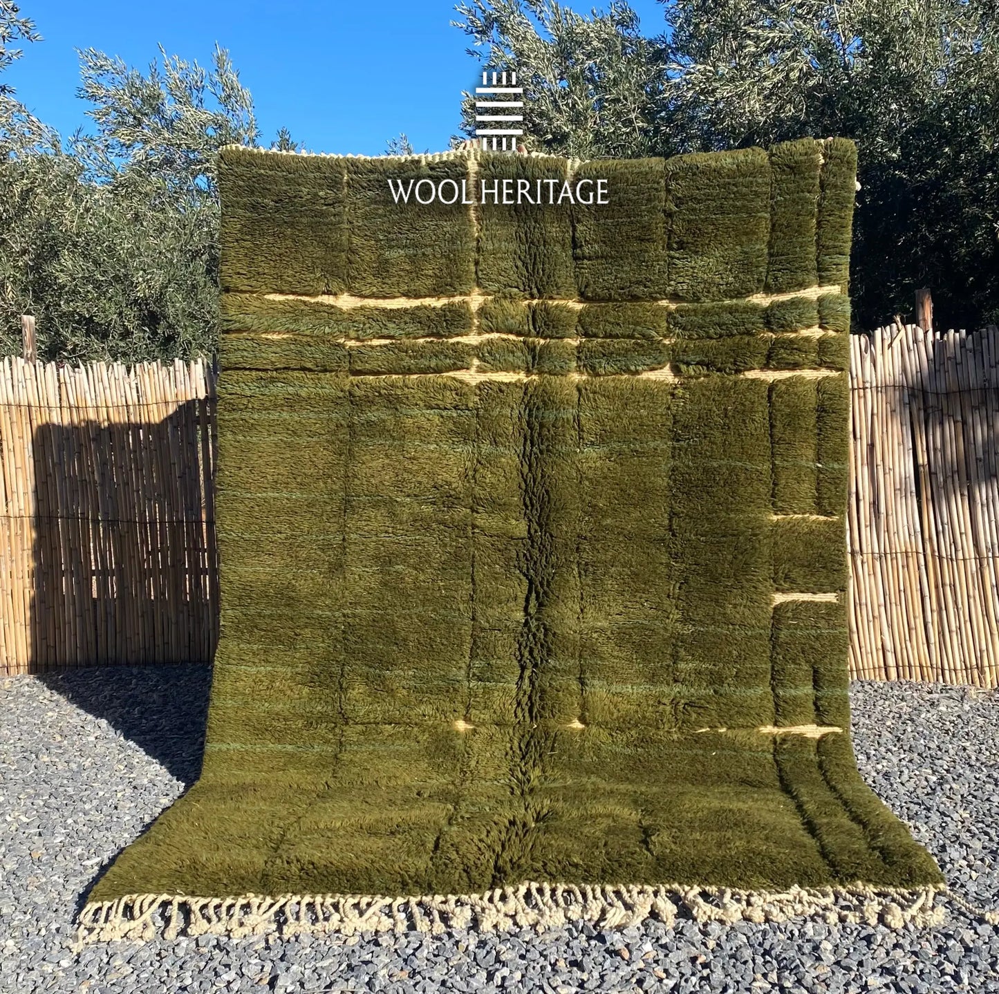 AZMMUR hand-knotted olive-green Moroccan wool rug displayed outdoors in a full front view