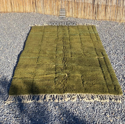 AZMMUR olive-green wool rug laid flat, showing its asymmetrical raised rectangular pattern