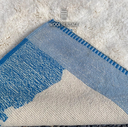 Back of IGENNA Beni Mrirt rug showing its woven construction, ivory center, blue colourwork, and finished edge