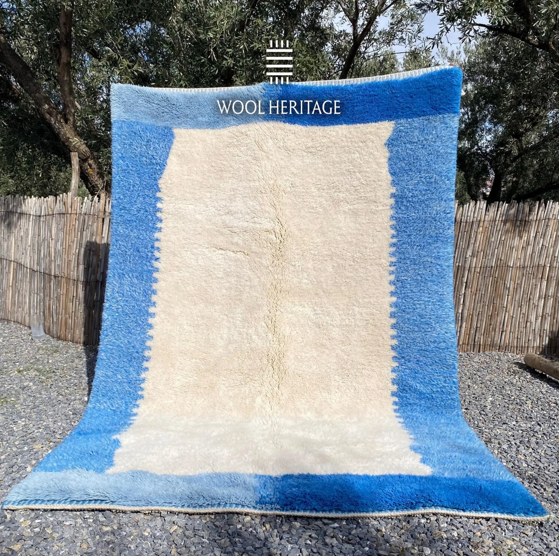 IGENNA hand-knotted blue and ivory Moroccan wool rug displayed outdoors in a full front view