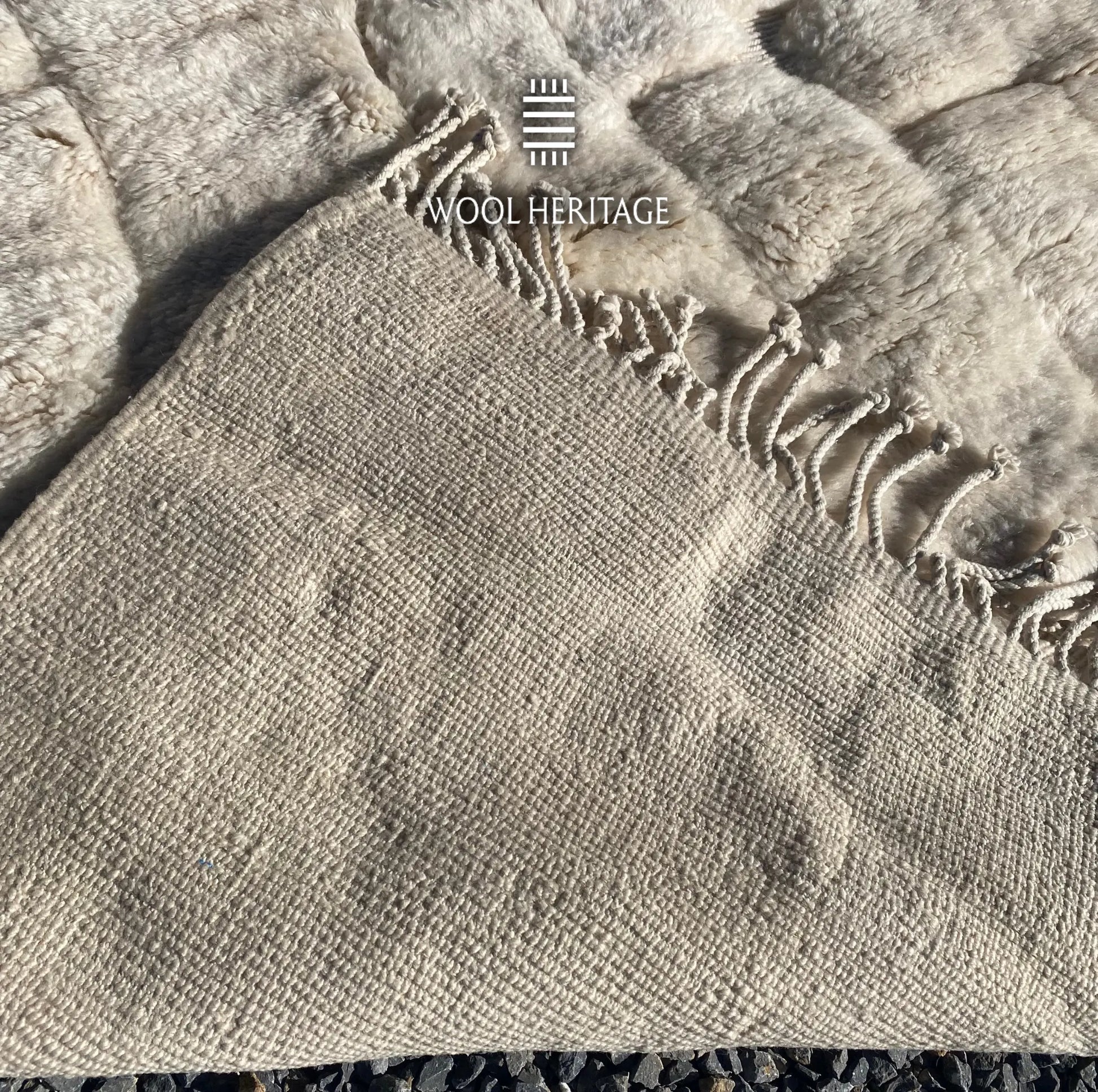 Back of IGHREM hand-knotted Moroccan rug showing its woven construction and fringe finish