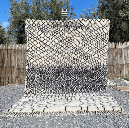 ITRAN hand-knotted black and ivory Moroccan wool rug displayed outdoors in a full front view
