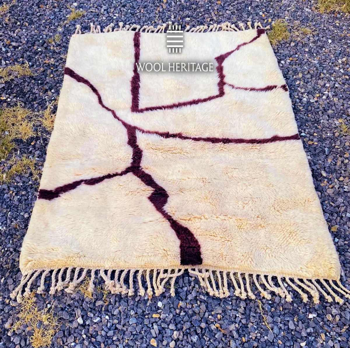 Lengthwise view of IZURAN Beni Mrirt rug laid flat, showing its complete branching burgundy composition on ivory