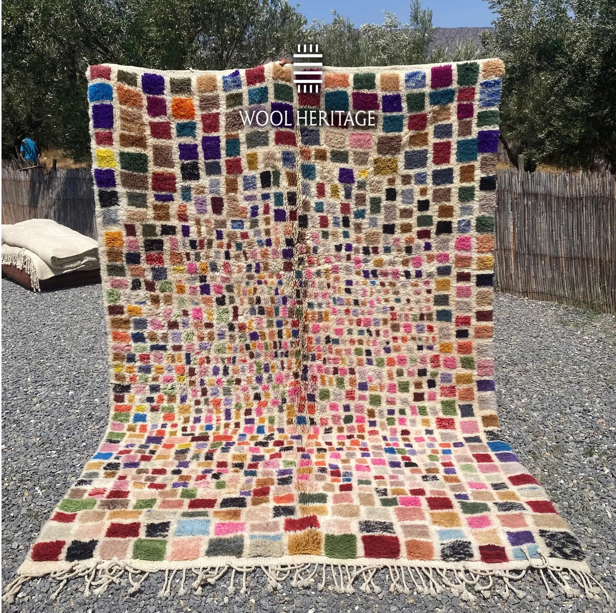 TAFSUT hand-knotted multicolour Moroccan wool rug displayed outdoors in a full front view with hand-finished fringe