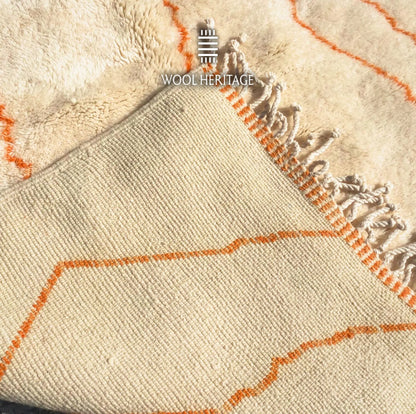 Back of TAFUKT Beni Mrirt rug showing its woven construction, orange colourwork, finished edge, and fringe