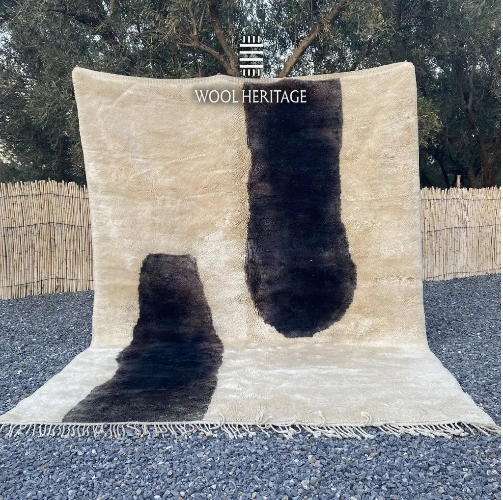 TAFUNAST hand-knotted black and ivory Moroccan wool rug displayed outdoors in a full front view with hand-finished fringe