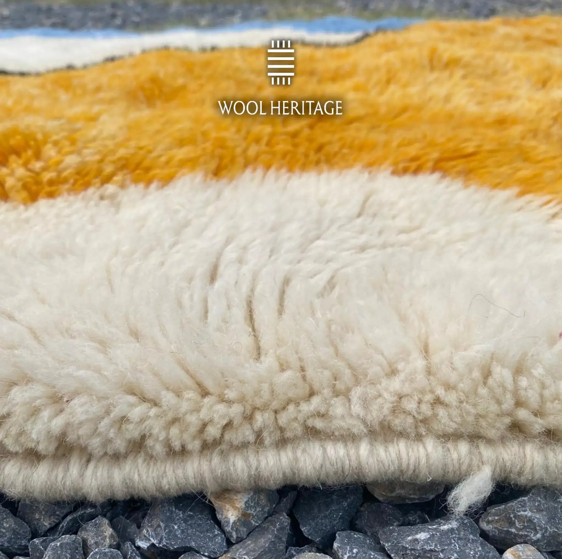 Close-up of TAMURT wool rug showing the soft golden ochre and ivory pile with natural tonal variation