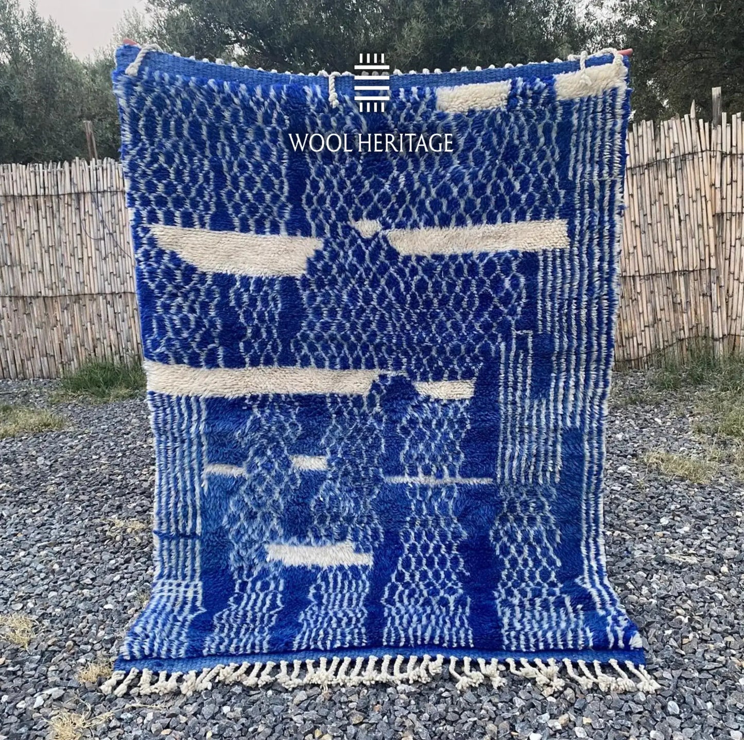 TARGA hand-knotted cobalt-blue and ivory Moroccan wool rug displayed outdoors in a full front view