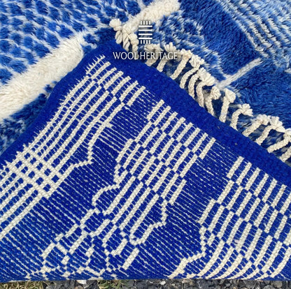 Back of TARGA Moroccan rug showing the woven cobalt-blue and ivory pattern, finished edge, and fringe