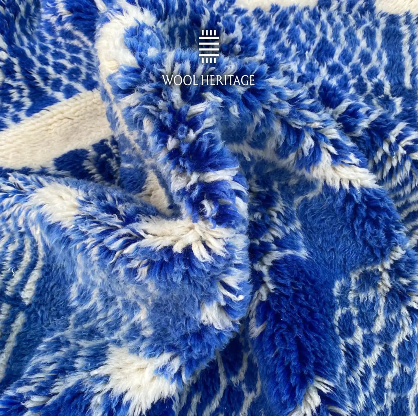 Detailed view of TARGA Beni Mrirt rug showing dense high-low blue and ivory wool textures