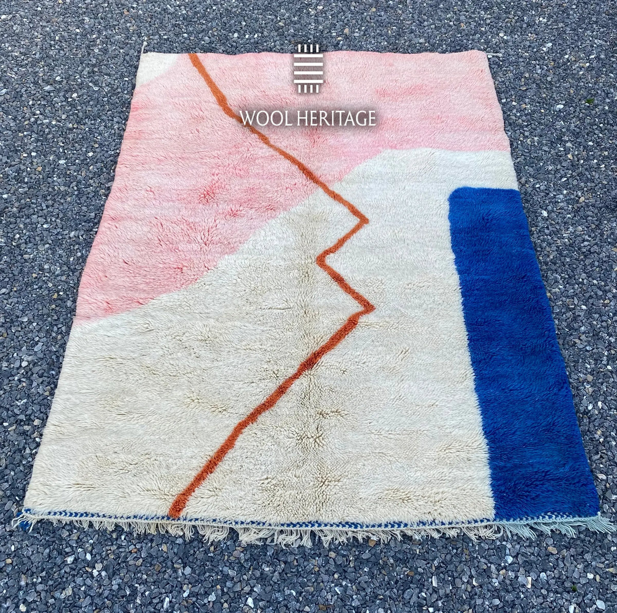TAYRI Beni Mrirt rug laid flat, showing its pink, ivory, cobalt-blue, and terracotta geometric composition