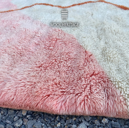 Close-up of TAYRI rug showing the soft pink wool pile, ivory section, and cobalt-blue colour block