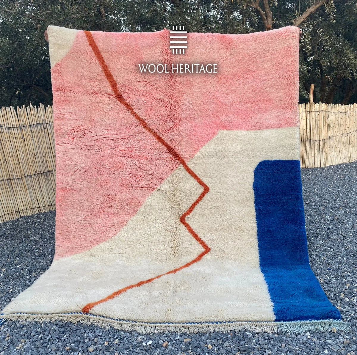 TAYRI hand-knotted pink, ivory, and blue Moroccan wool rug displayed outdoors in a full front view