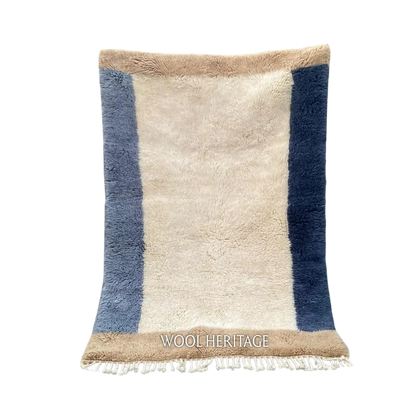 TIFAWT blue and ivory Beni Mrirt rug with asymmetrical side bands and warm beige ends in an isolated product view