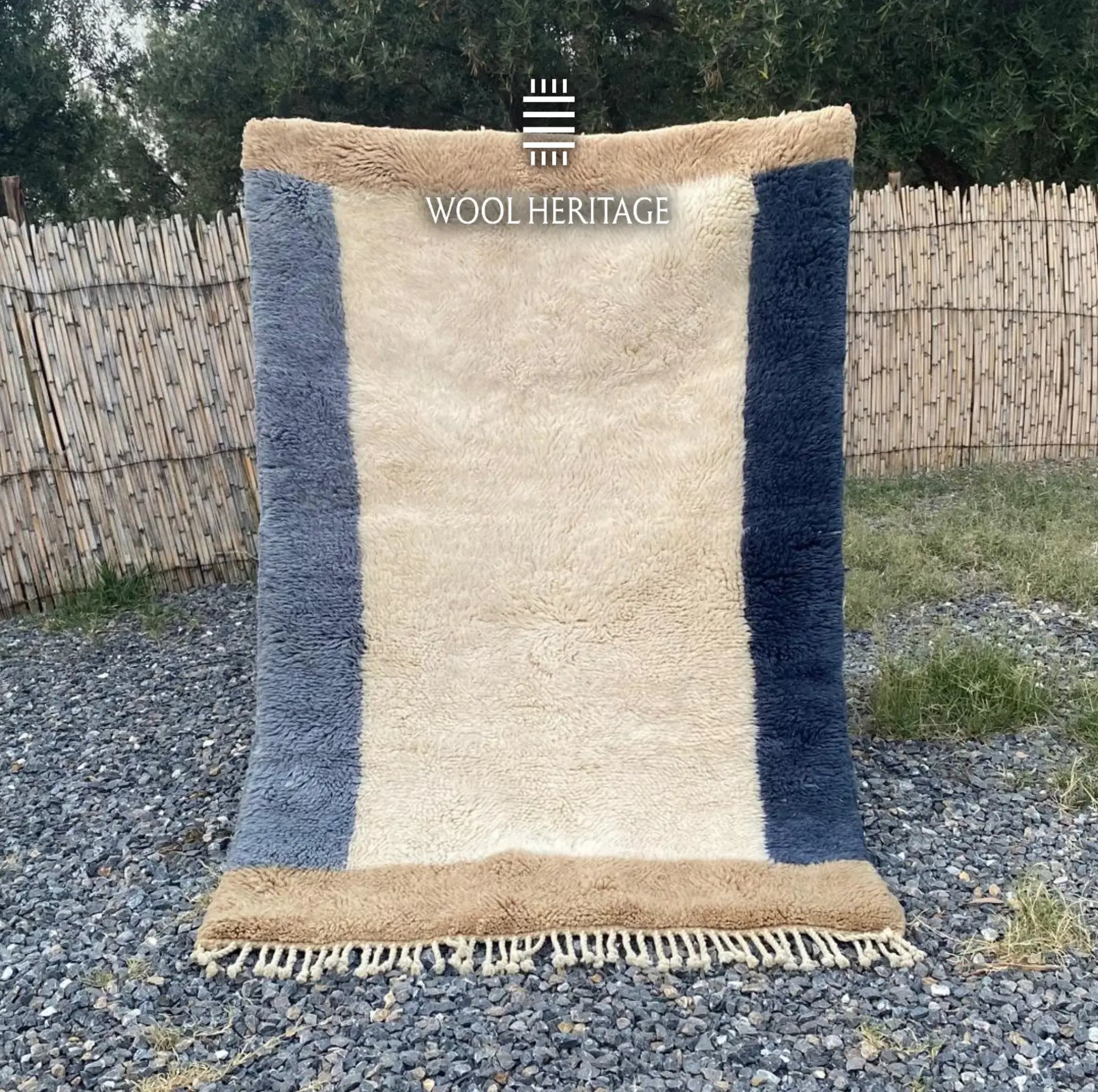 TIFAWT hand-knotted blue, ivory, and beige Moroccan wool rug displayed outdoors in a full front view