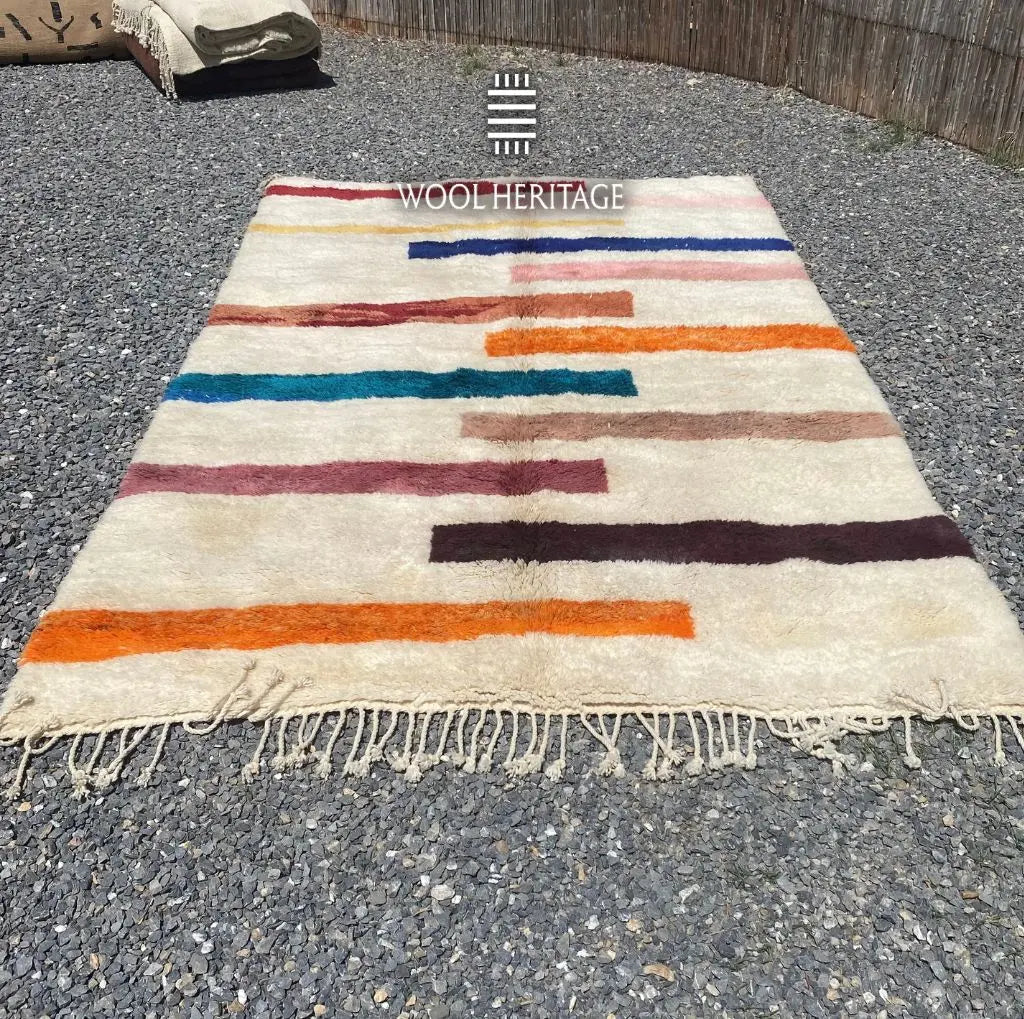 TIGRAT multicolour Beni Mrirt rug laid flat, showing its uneven horizontal stripe composition