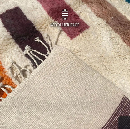 TIGRAT rug close-up showing the woven backing, finished edge, and fringe