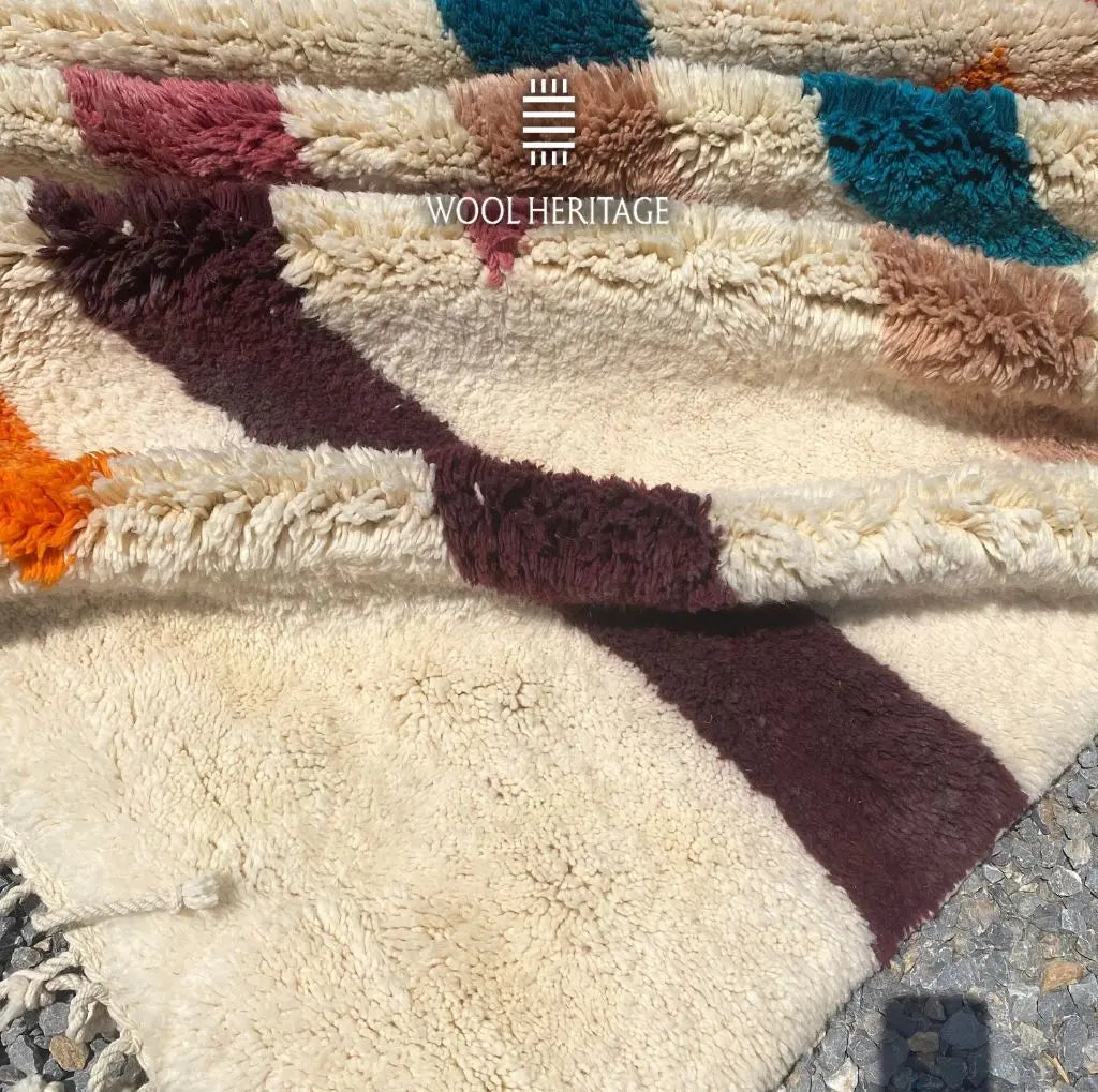 Close-up of TIGRAT’s colourful high-low wool pile and textured horizontal bands