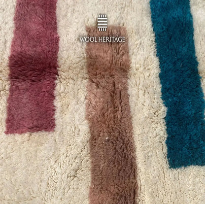 Close-up of TIGRAT’s burgundy, pink, ochre, and navy woven bands