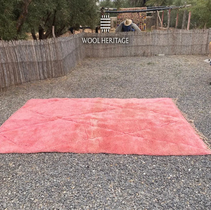 TISLIT coral-pink Moroccan rug shown flat from the front on gravel