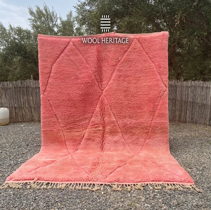 TISLIT coral-pink Moroccan wool rug shown upright outdoors