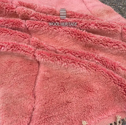 Close-up of TISLIT’s soft coral-pink high-low wool pile