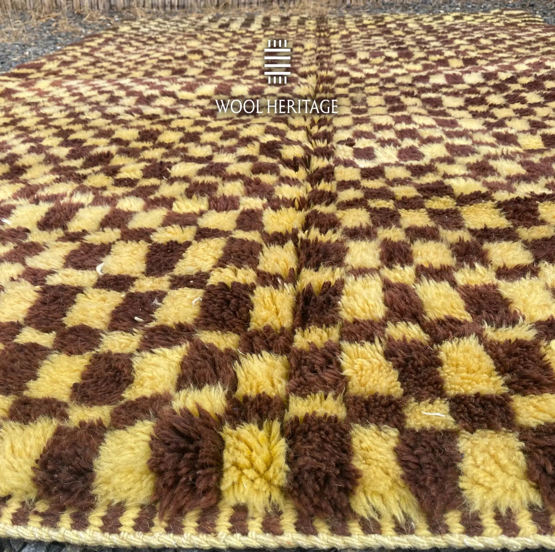 Low-angle detail of TIZWIT Beni Mrirt rug showing the soft pile and changing checker proportions