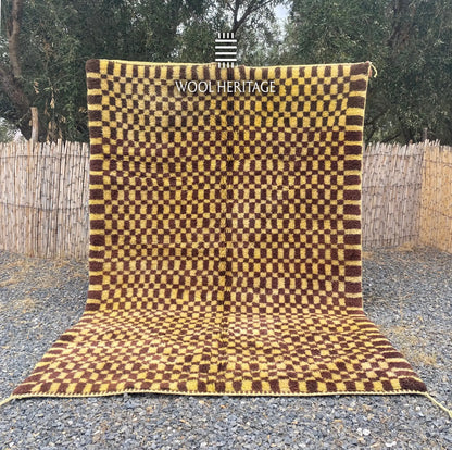 TIZWIT hand-knotted golden-yellow and brown Moroccan wool rug displayed outdoors in a full front view