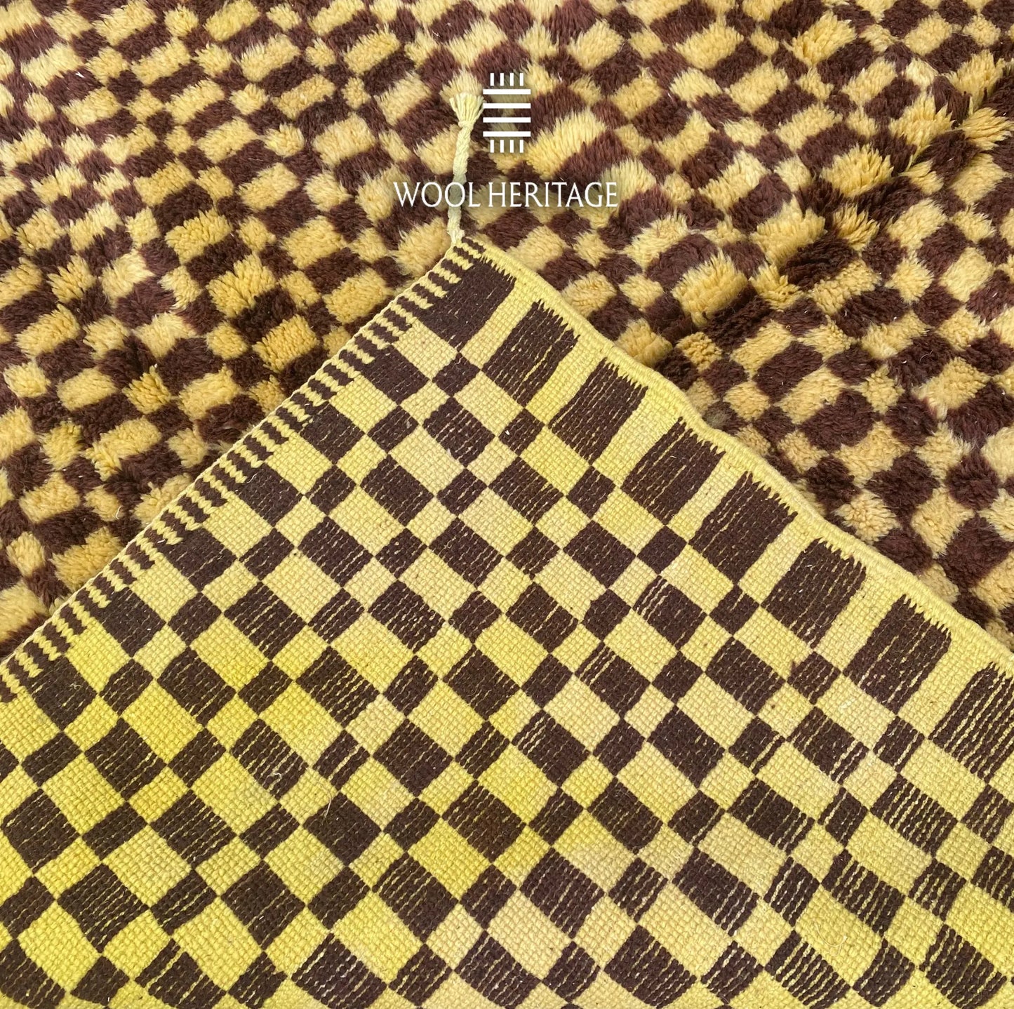 Back of TIZWIT Moroccan rug showing the woven checkerboard construction and finished edge