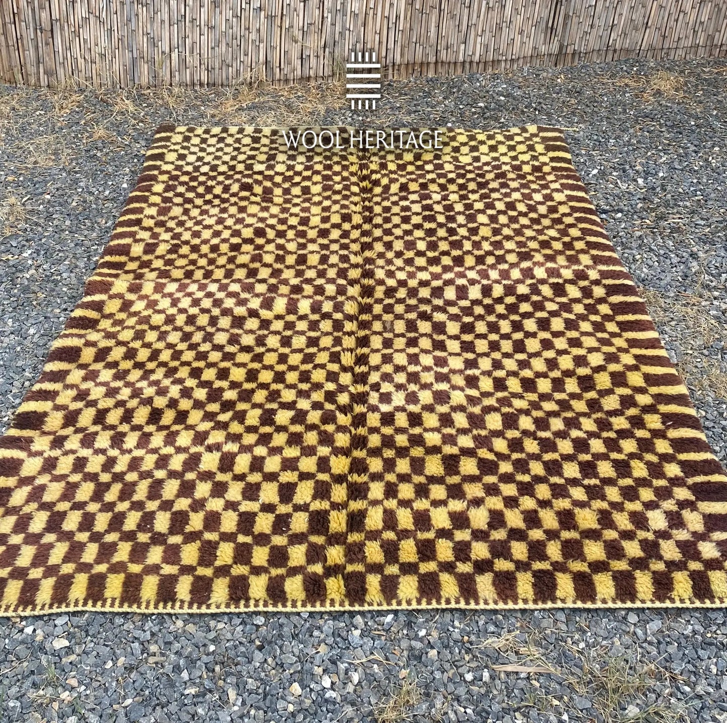 TIZWIT golden-yellow and brown wool rug laid flat, showing the full hand-drawn checkerboard pattern