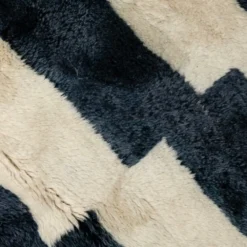 Handmade black and white abstract Moroccan rug with stepped geometric pattern, crafted in natural wool by Berber artisans.