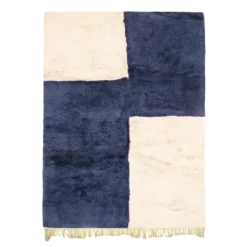 Handwoven blue abstract Moroccan area rug with indigo and white color blocks, made in natural wool by Beni Mrirt artisans.